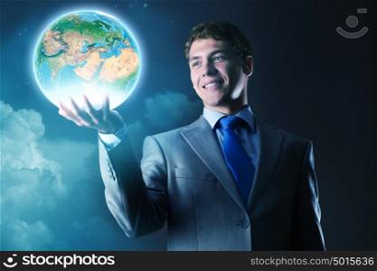 Our Earth planet. Young businessman holding Earth planet in hand. Elements of this image are furnished by NASA