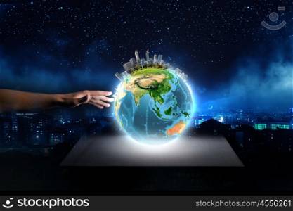 Our home. Close up of human hand holding Earth planet. Elements of this image are furnished by NASA