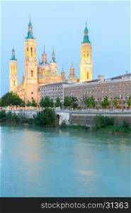 Our Lady of the Pillar Basilica with Ebro River at dusk Zaragoza, Spain