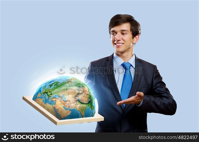 Our planet Earth. Handsome businessman holding frame with Earth planet. Elements of this image are furnished by NASA