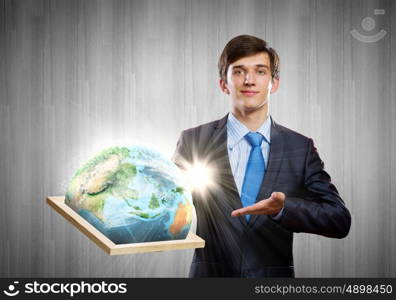 Our planet Earth. Handsome businessman holding frame with Earth planet. Elements of this image are furnished by NASA