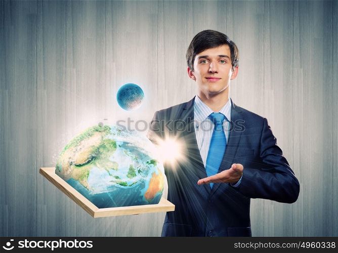 Our planet Earth. Handsome businessman holding frame with Earth planet. Elements of this image are furnished by NASA