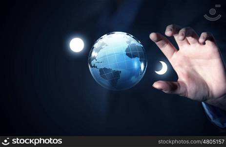 Our technology world. Close view of businessman taking digital Earth planet