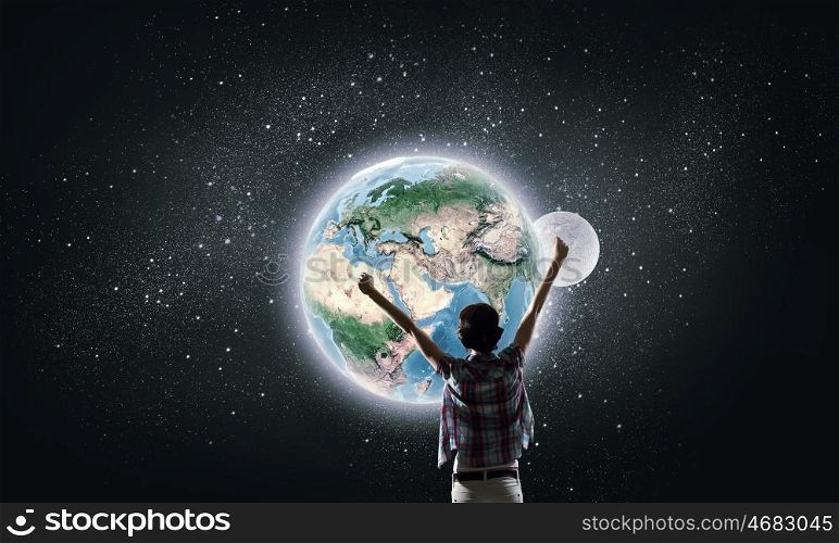 Our universe. Back view of girl with hands up looking at planets. Elements of this image are furnished by NASA