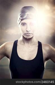 Outddor portrait od Young athletic swimer woman with googles and swimming cap
