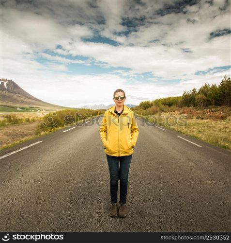 Outddor portrait of a woman in the middle of a beautiful road