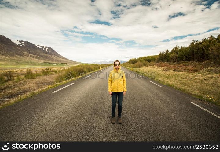 Outddor portrait of a woman in the middle of a beautiful road
