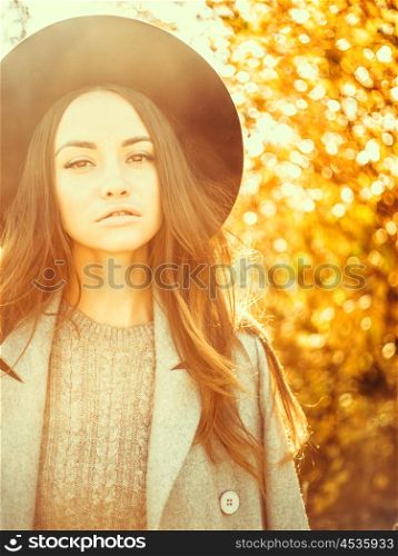 Outdoor atmospheric fashion photo of young beautiful lady in autumn landscape