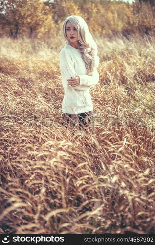 Outdoor atmospheric fashion photo of young beautiful lady in autumn landscape