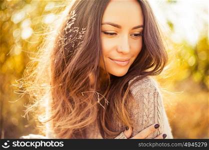 Outdoor atmospheric lifestyle photo of young beautiful lady. Brown hair and eyes. Warm autumn. Warm spring