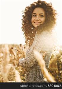 Outdoor atmospheric lifestyle photo of young beautiful lady. Brown hair and eyes. Warm fall. Autumn vibes. Softness, warmth and comfort