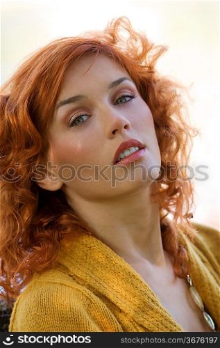 outdoor close up of red-haired woman and light eyes