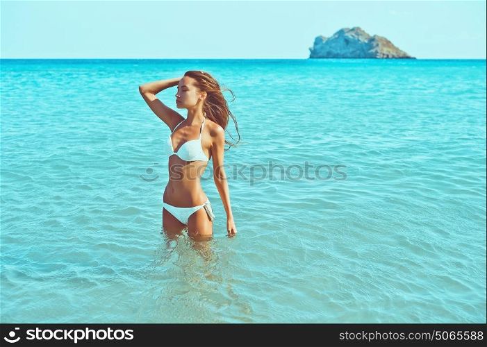 Outdoor fashion photo of beautiful happy slender woman at sea. Beach travel. Summer vibes