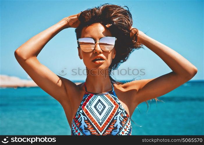 Outdoor fashion photo of beautiful happy woman at sea. Beach travel. Summer vibes