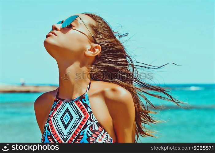 Outdoor fashion photo of beautiful happy woman at sea. Beach travel. Summer vibes