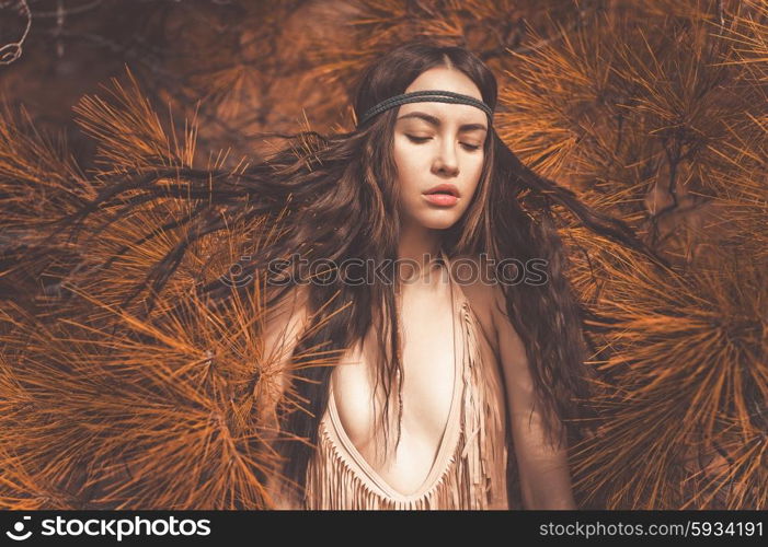 Outdoor fashion photo of beautiful lady hippie in a fir forest