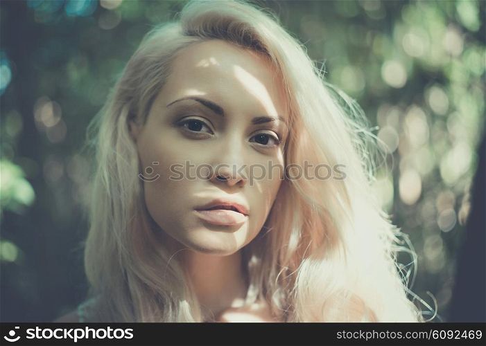 Outdoor fashion photo of young beautiful blonde lady