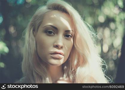 Outdoor fashion photo of young beautiful blonde lady
