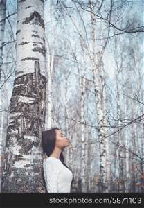 Outdoor fashion photo of young beautiful lady in a birch forest