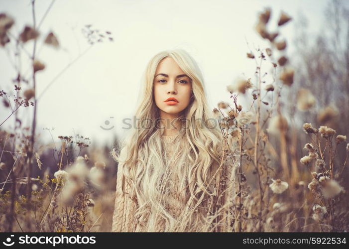 Outdoor fashion photo of young beautiful lady in autumn landscape