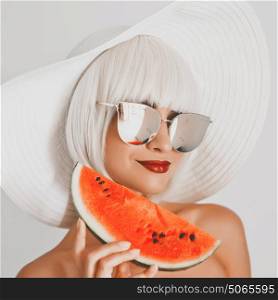 Outdoor fashion photo of young beautiful lady in hat and sunglasses with watermelon. Summer Beach travel. Summer vibes