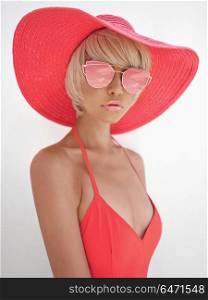 Outdoor fashion photo of young beautiful lady in red hat and sunglasses. Summer Beach travel. Summer vibes. Beautiful lady in red hat and sunglasses