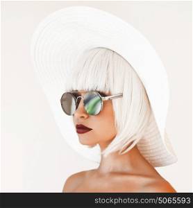 Outdoor fashion photo of young beautiful lady in white hat and mirror sunglasses. Summer Beach travel. Summer vibes