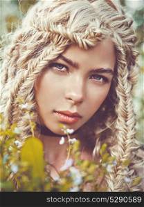 Outdoor fashion portrait of beautiful blonde young girl with pigtails hairstyle. Spring-Summer vibes. Warm autumn. Youth and freshness