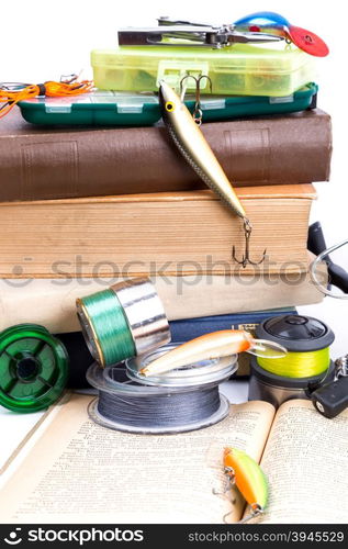 outdoor fishing tackles and baits with books on white background