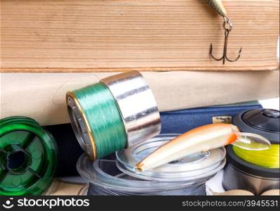 outdoor fishing tackles and baits with books on white background