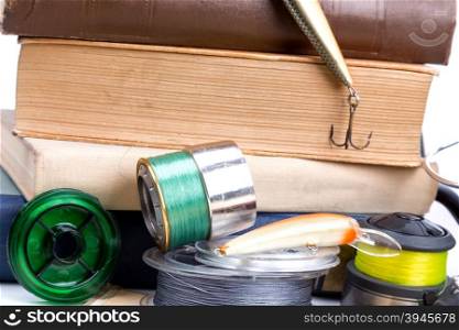 outdoor fishing tackles and baits with books on white background