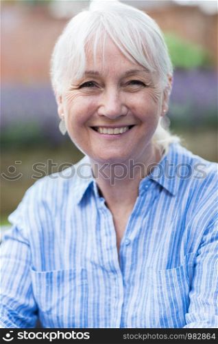 Outdoor Head And Shoulders Portrait Of Mature Woman