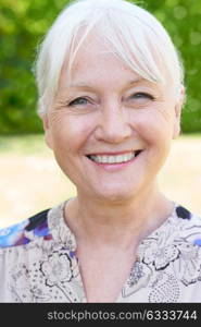 Outdoor Head And Shoulders Portrait Of Senior Woman