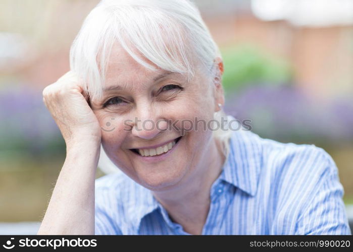 Outdoor Head And Shoulders Portrait Of Senior Woman