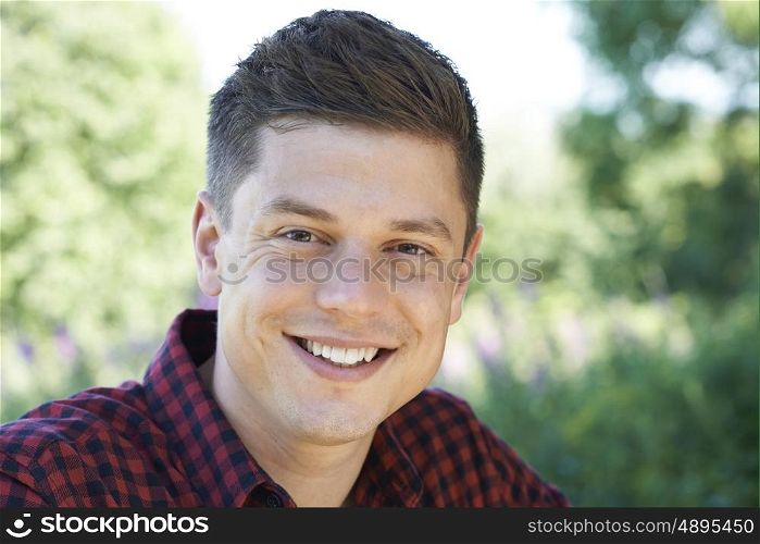 Outdoor Head And Shoulders Portrait Of Smiling Man
