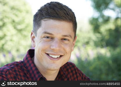 Outdoor Head And Shoulders Portrait Of Smiling Man