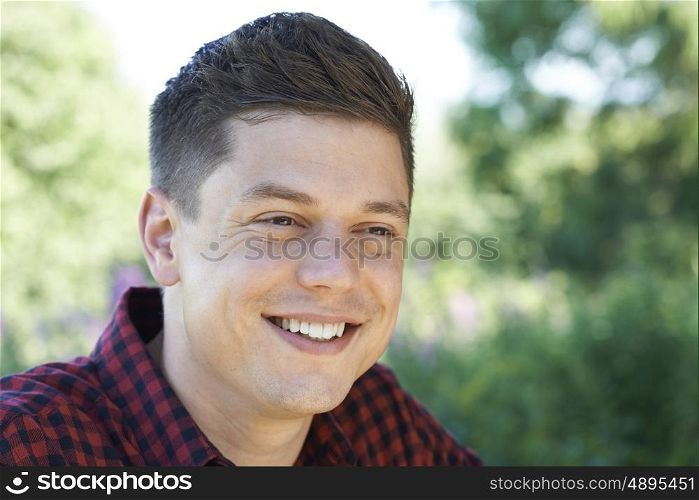 Outdoor Head And Shoulders Portrait Of Smiling Man