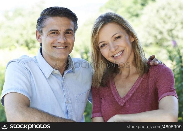 Outdoor Head And Shoulders Portrait Of Smiling Mature Couple
