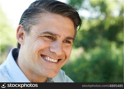 Outdoor Head And Shoulders Portrait Of Smiling Mature Man