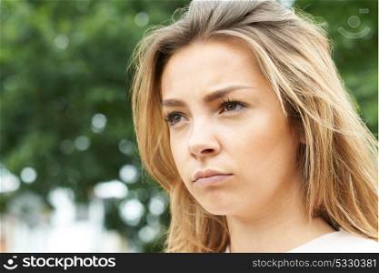 Outdoor Head And Shoulders Shot Of Serious Teenage Girl