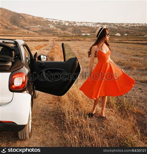 Outdoor lifestyle photo of beautiful stylish woman in car cabriolet. Holiday and travel. Summer trip. Freedom, youth and carefree
