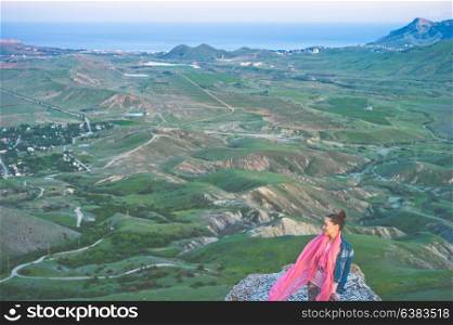 Outdoor lifestyle photo of young happy woman walking on mountain. Travel background. Tourism