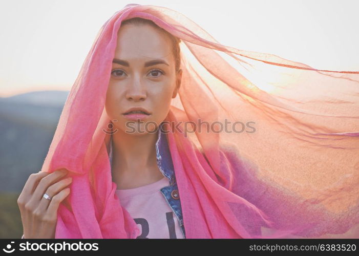 Outdoor lifestyle photo of young happy woman walking on mountain. Travel background. Tourism