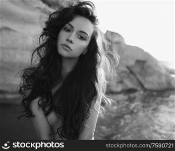Outdoor lifestyle portrait of beautiful young brunette woman on the beach. Natural beauty. Travel and youth. Summer vibes
