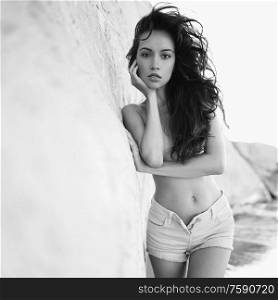 Outdoor lifestyle portrait of beautiful young brunette woman topless on the beach. Natural beauty. Travel and youth. Summer vibes