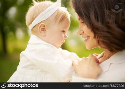 Outdoor lifestyle portrait of happy young beautiful mother and little cute daughter. Family, Love and Care. Summer image