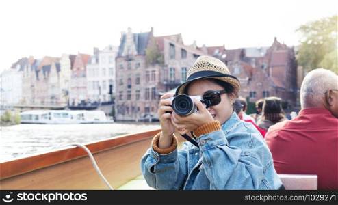 Outdoor lifestyle portrait of pretty young woman having fun in the city in Europe with digital camera travel photo of photographer Making pictures in hipster style