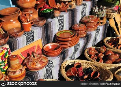 Outdoor market stall selling Mexican pottery