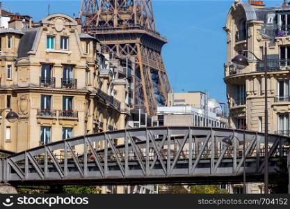 Outdoor metro bridge on the background of the Eiffel Tower on a sunny morning. Paris. France... Paris. Metro bridge on the background of the Eiffel Tower.
