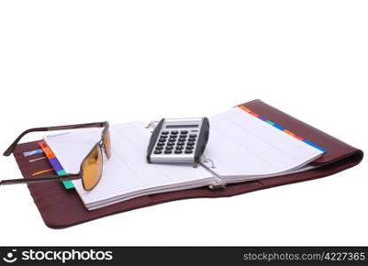 Outdoor notebook book with glasses and a calculator on a white background.